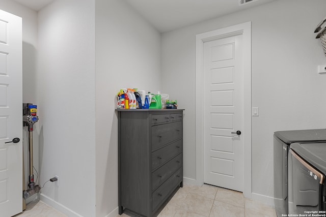 laundry room featuring light tile patterned floors and washer and dryer