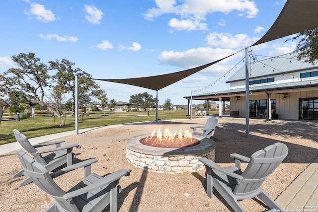 view of home's community with a yard and a fire pit