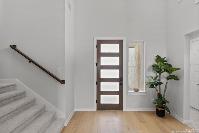 1521 Escarpment, New Braunfels, TX 78132 - entryway with light wood finished floors, baseboards, stairs, and a high ceiling