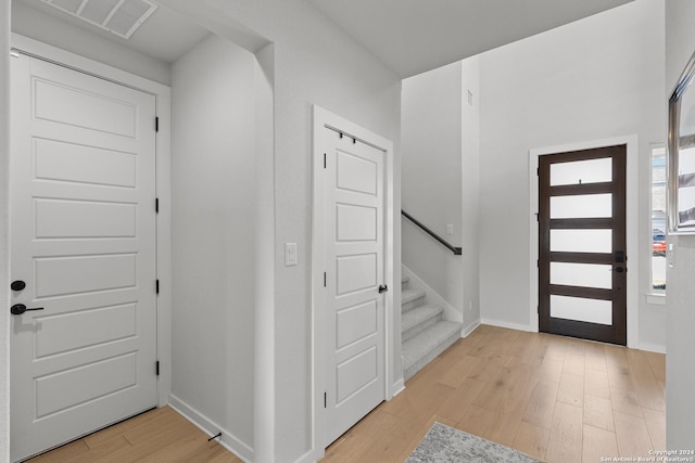 1521 Escarpment, New Braunfels, TX 78132 - foyer featuring light wood finished floors, stairway, and baseboards