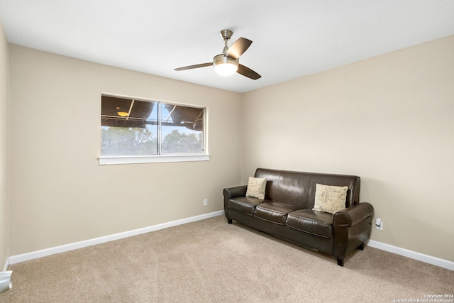 living area featuring ceiling fan and light colored carpet