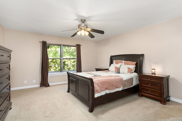 bedroom featuring ceiling fan and light carpet