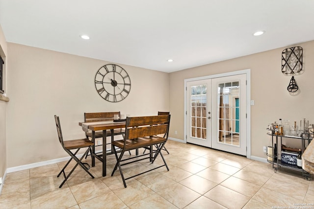 dining room with french doors and light tile patterned floors