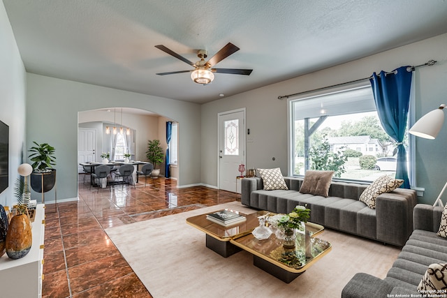 living room featuring a textured ceiling and ceiling fan