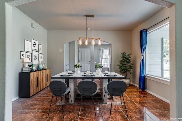 dining space with a textured ceiling