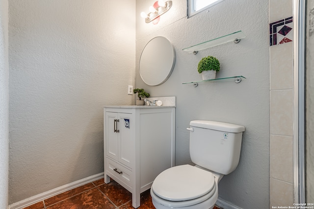 bathroom with tile patterned flooring, vanity, and toilet