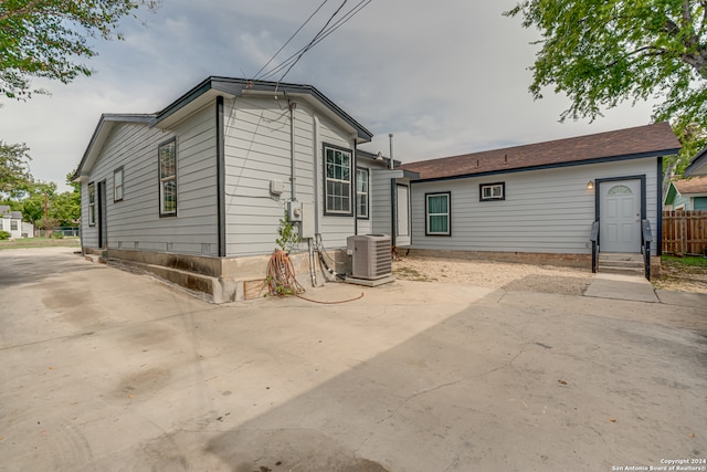 rear view of property with a patio and central AC unit