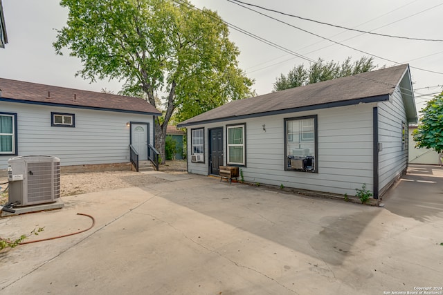 back of property with cooling unit and a patio