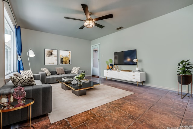 tiled living room with ceiling fan