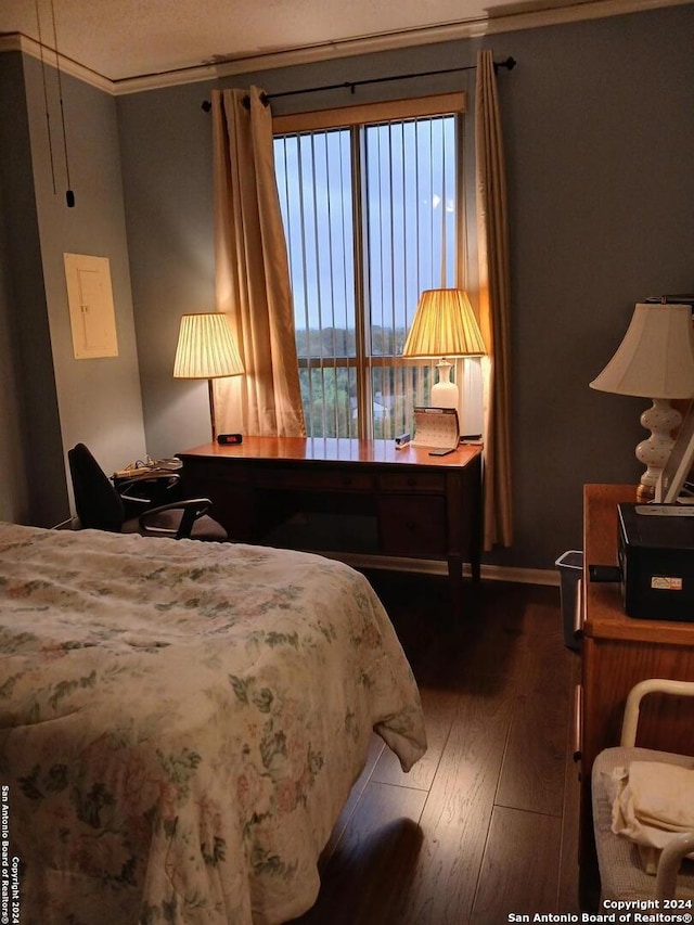 bedroom with crown molding and hardwood / wood-style flooring