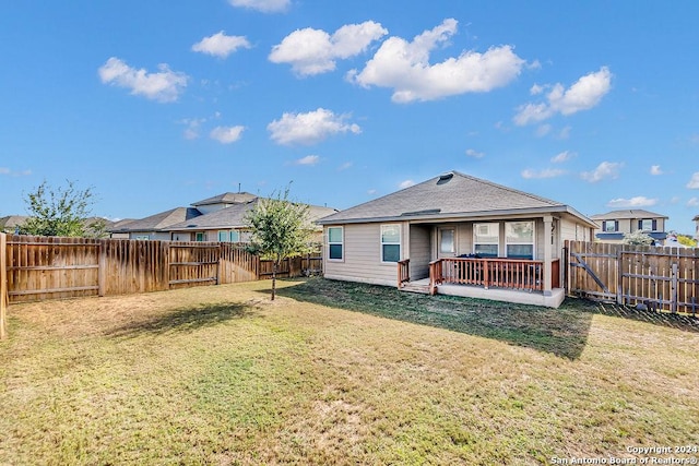 rear view of house with a lawn and a patio area