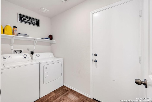 washroom with washer and clothes dryer and dark wood-type flooring