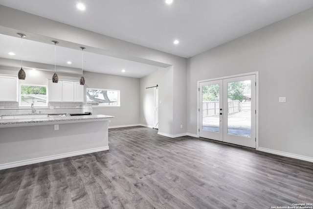 kitchen featuring hanging light fixtures, french doors, white cabinets, and a healthy amount of sunlight