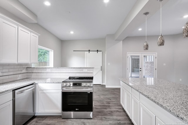 kitchen featuring white cabinetry, french doors, hanging light fixtures, dark wood-type flooring, and appliances with stainless steel finishes