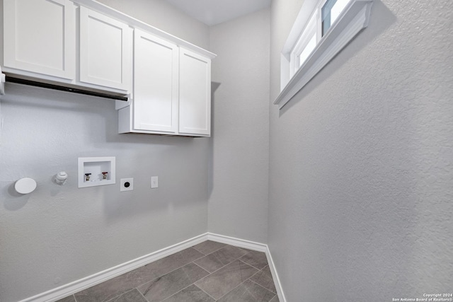 laundry area featuring hookup for an electric dryer, washer hookup, and cabinets