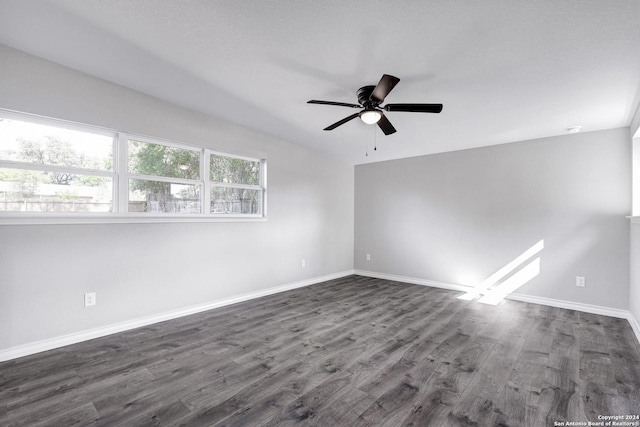 spare room featuring ceiling fan and dark wood-type flooring