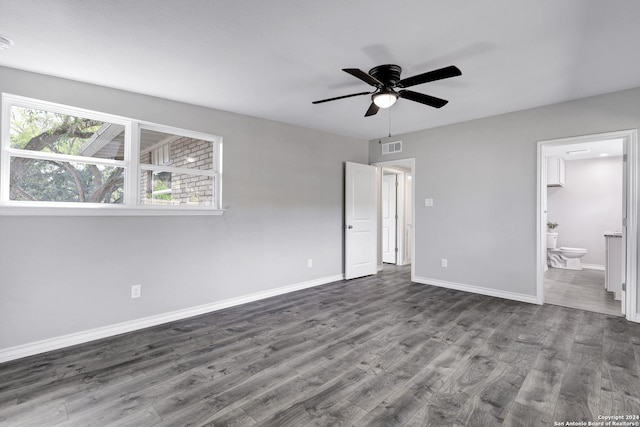 unfurnished bedroom featuring ceiling fan, ensuite bathroom, and wood-type flooring