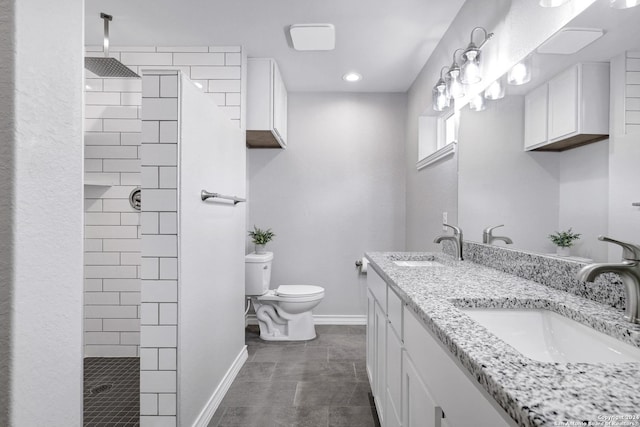 bathroom with tile patterned floors, toilet, vanity, and tiled shower