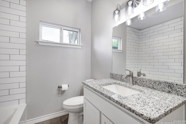 bathroom with tile patterned floors, vanity, and toilet