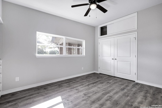 unfurnished bedroom featuring wood-type flooring, a closet, and ceiling fan