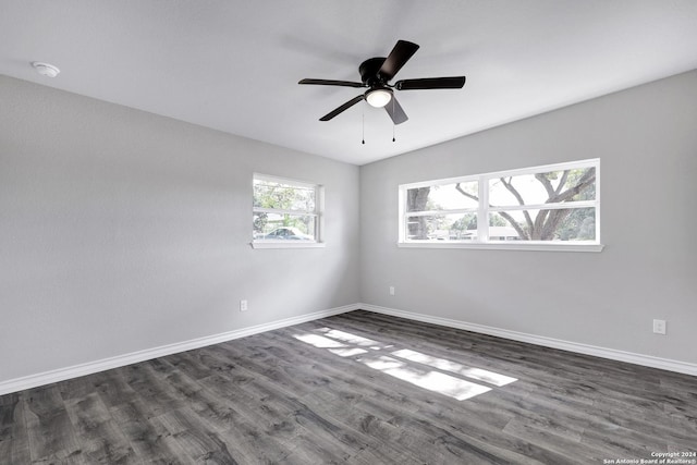 spare room featuring dark hardwood / wood-style floors and ceiling fan