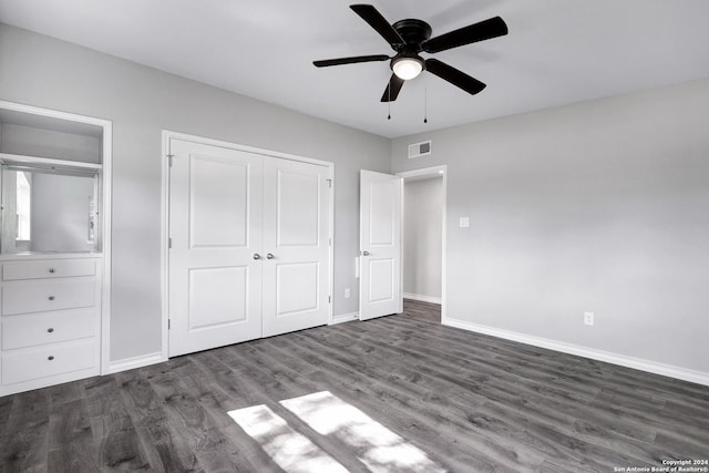 unfurnished bedroom featuring ceiling fan and dark hardwood / wood-style flooring