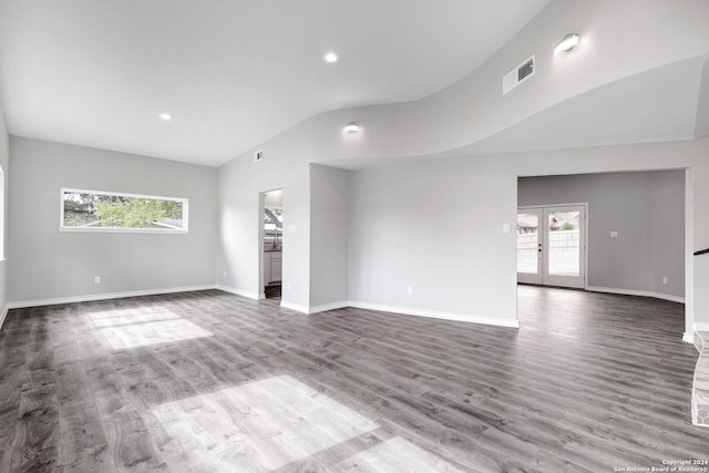 unfurnished living room with french doors, wood-type flooring, and lofted ceiling