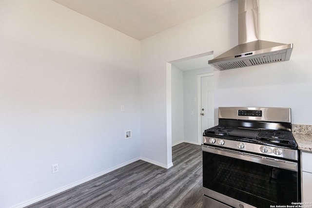 kitchen with light stone counters, stainless steel gas range oven, wall chimney exhaust hood, dark hardwood / wood-style floors, and white cabinetry