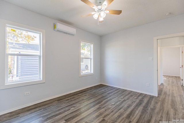 unfurnished room with dark hardwood / wood-style flooring, an AC wall unit, and ceiling fan