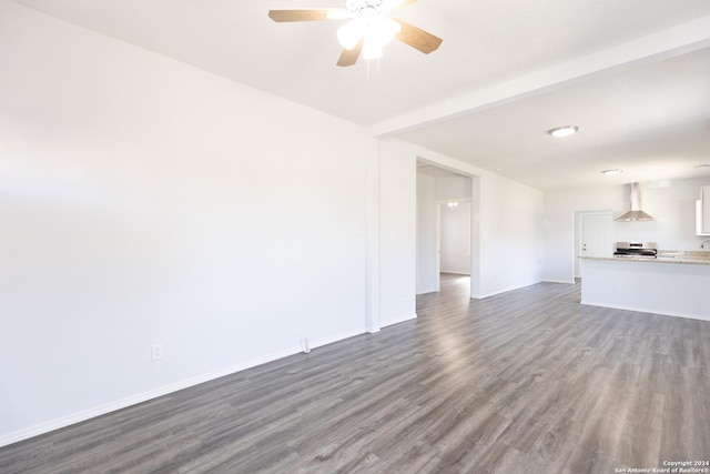 unfurnished living room with ceiling fan and dark hardwood / wood-style flooring