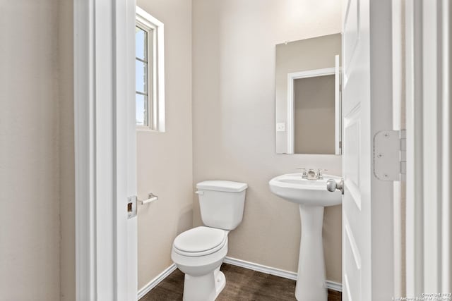 bathroom with hardwood / wood-style flooring, sink, and toilet