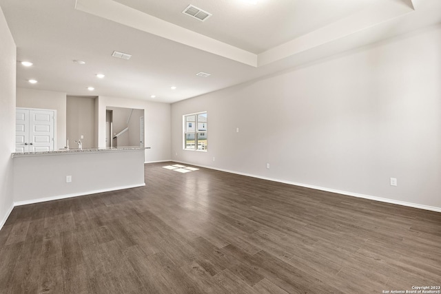 unfurnished living room featuring dark hardwood / wood-style flooring