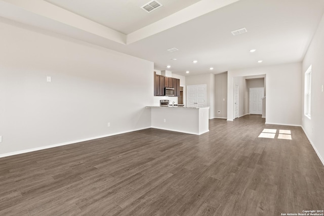 unfurnished living room featuring dark hardwood / wood-style flooring