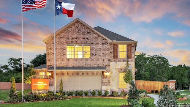 view of front property featuring a garage and a lawn