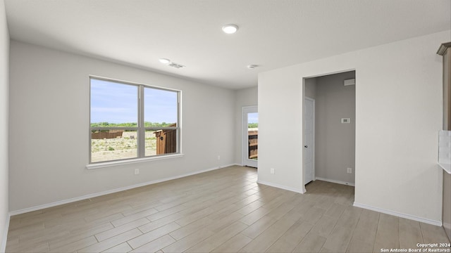 spare room with light hardwood / wood-style flooring