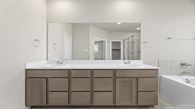 bathroom featuring tile patterned floors, vanity, and separate shower and tub