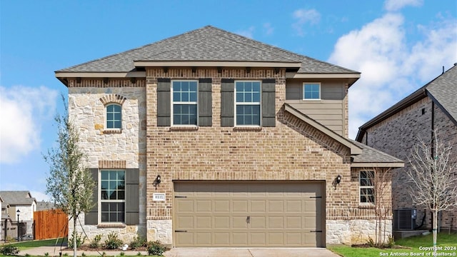 view of front of home featuring a garage and central air condition unit