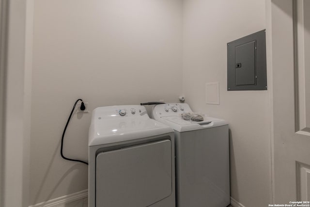 washroom with washing machine and dryer and electric panel