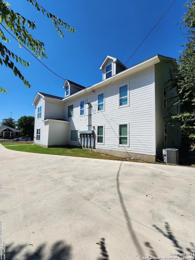 rear view of property featuring central air condition unit