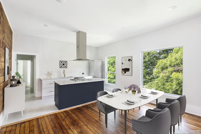 dining room featuring sink and light hardwood / wood-style flooring