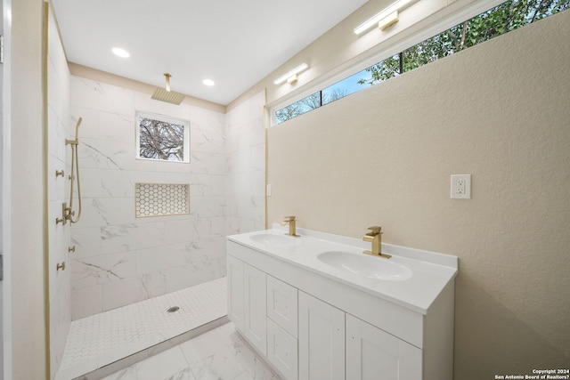 bathroom featuring vanity and tiled shower