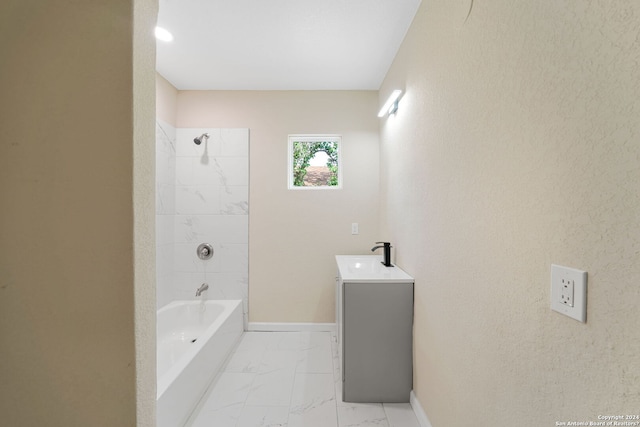 bathroom featuring vanity and tiled shower / bath