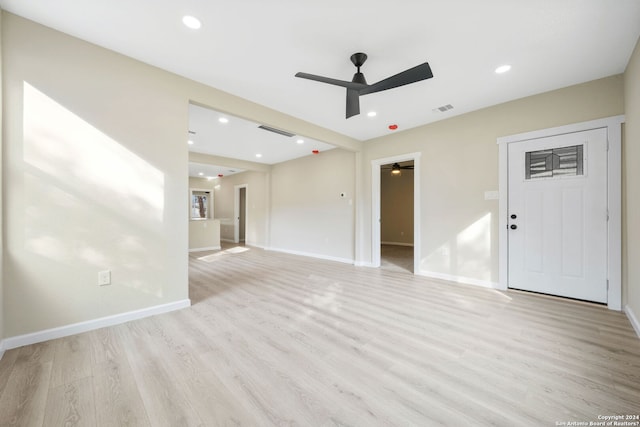 unfurnished living room featuring ceiling fan and light hardwood / wood-style flooring