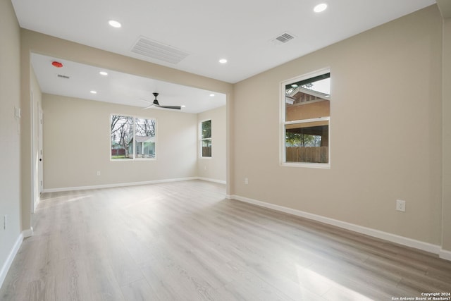 unfurnished room with ceiling fan and light hardwood / wood-style flooring