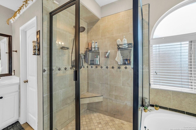 bathroom featuring vanity and separate shower and tub