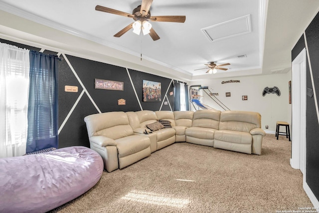 carpeted living room with ceiling fan and ornamental molding