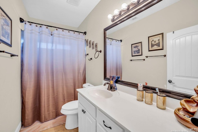 bathroom with tile patterned flooring, a shower with curtain, vanity, and toilet