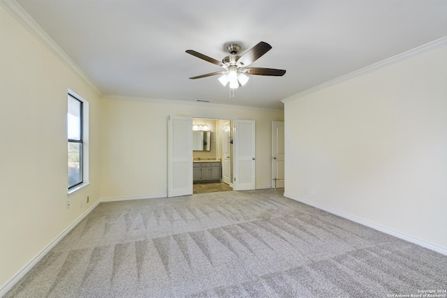 spare room featuring light colored carpet, ceiling fan, and crown molding