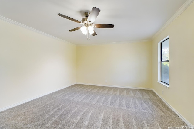 carpeted empty room featuring crown molding and ceiling fan