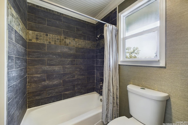 bathroom with crown molding, shower / bath combination with curtain, and toilet